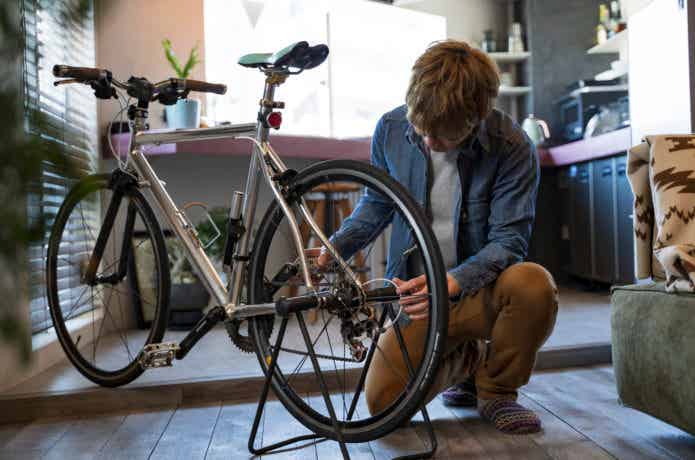 クロスバイクのメンテナンスをする男性