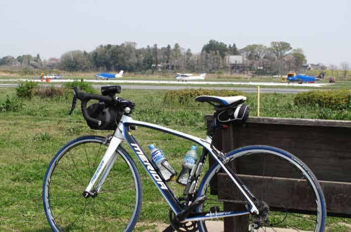 飛行場横で休憩中のロードバイク