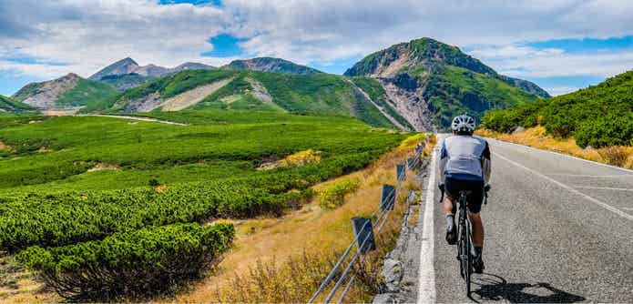 ロードバイクで峠を走る男性