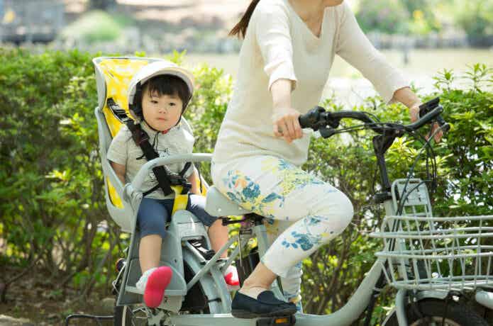 子乗せ自転車に乗った女性と子ども